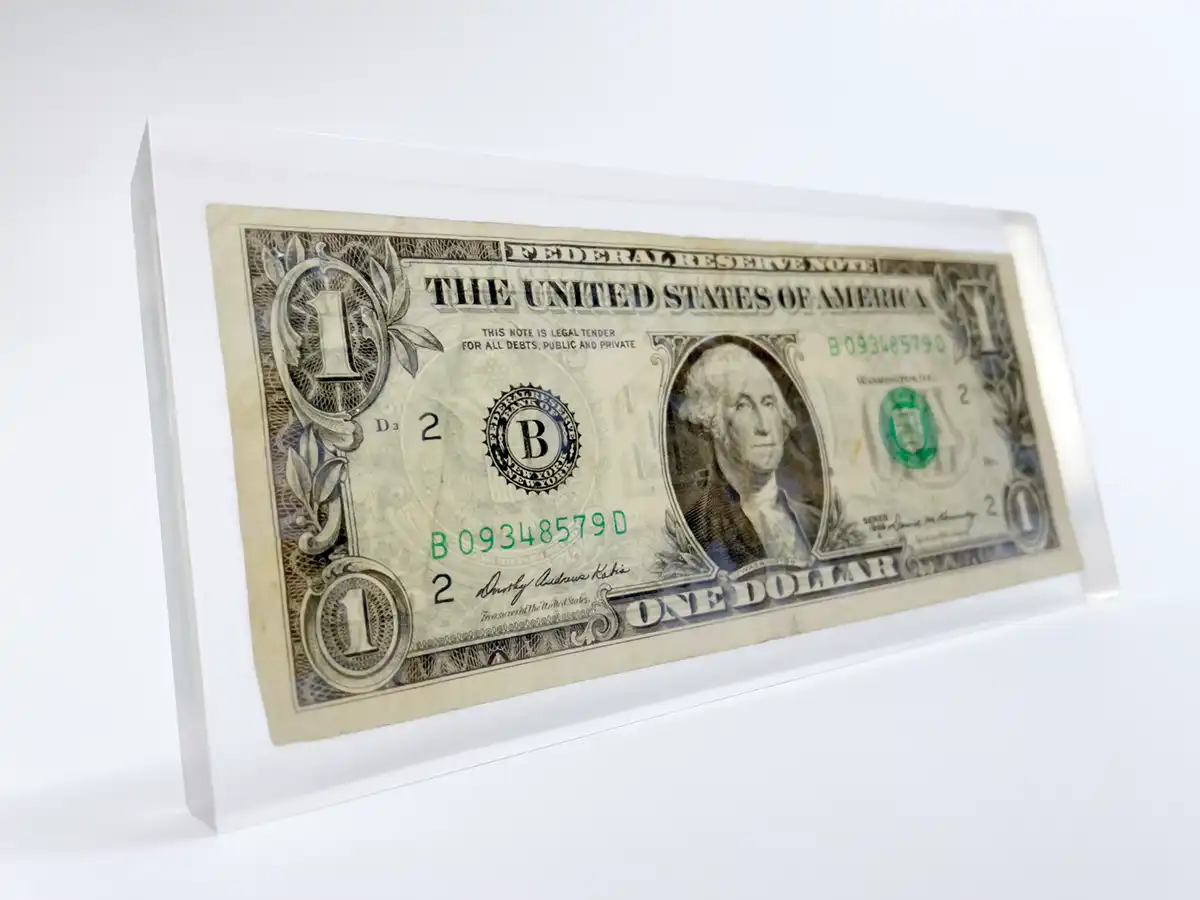 Eine One Dollar Note in einem Kunstharzblock eingegossen